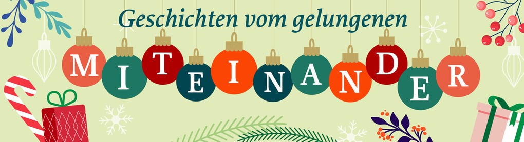 Weihnachtsbaumkugeln mit dem Schriftzug "Miteinander" und Tannengrün