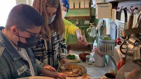 Schülerinnen und Schüler beim Kochen in einer alten Küche im Hessenpark